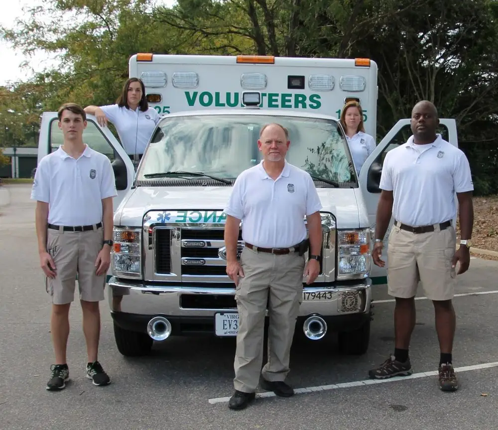 VBVRS volunteers posed in front of an ambulance marked Volunteers